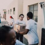 Volunteers Passing Boxes to Each Other